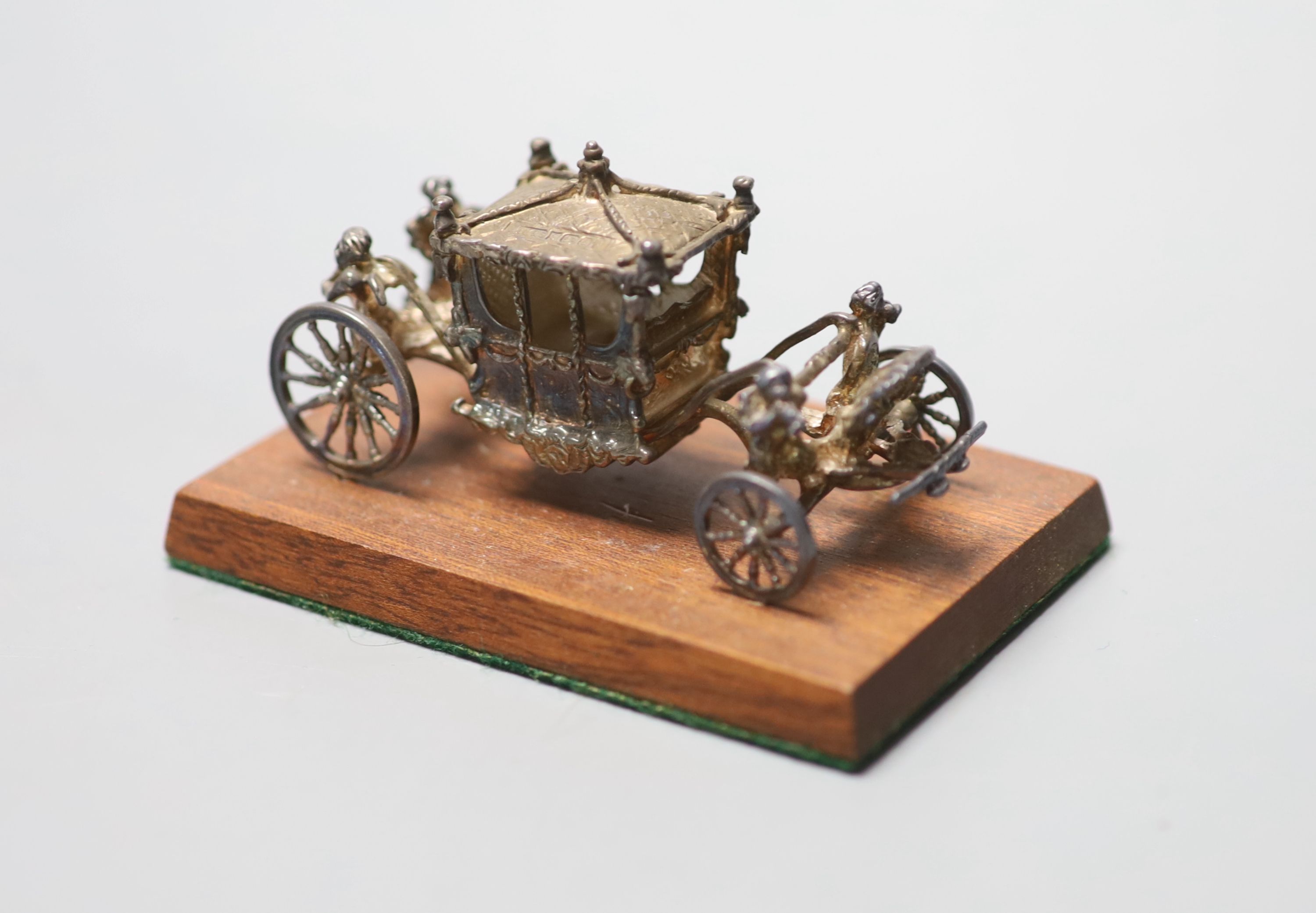 A 1970s miniature silver model of the Coronation coach, London, 1977, 75mm, fixed on a wooden base, in box.